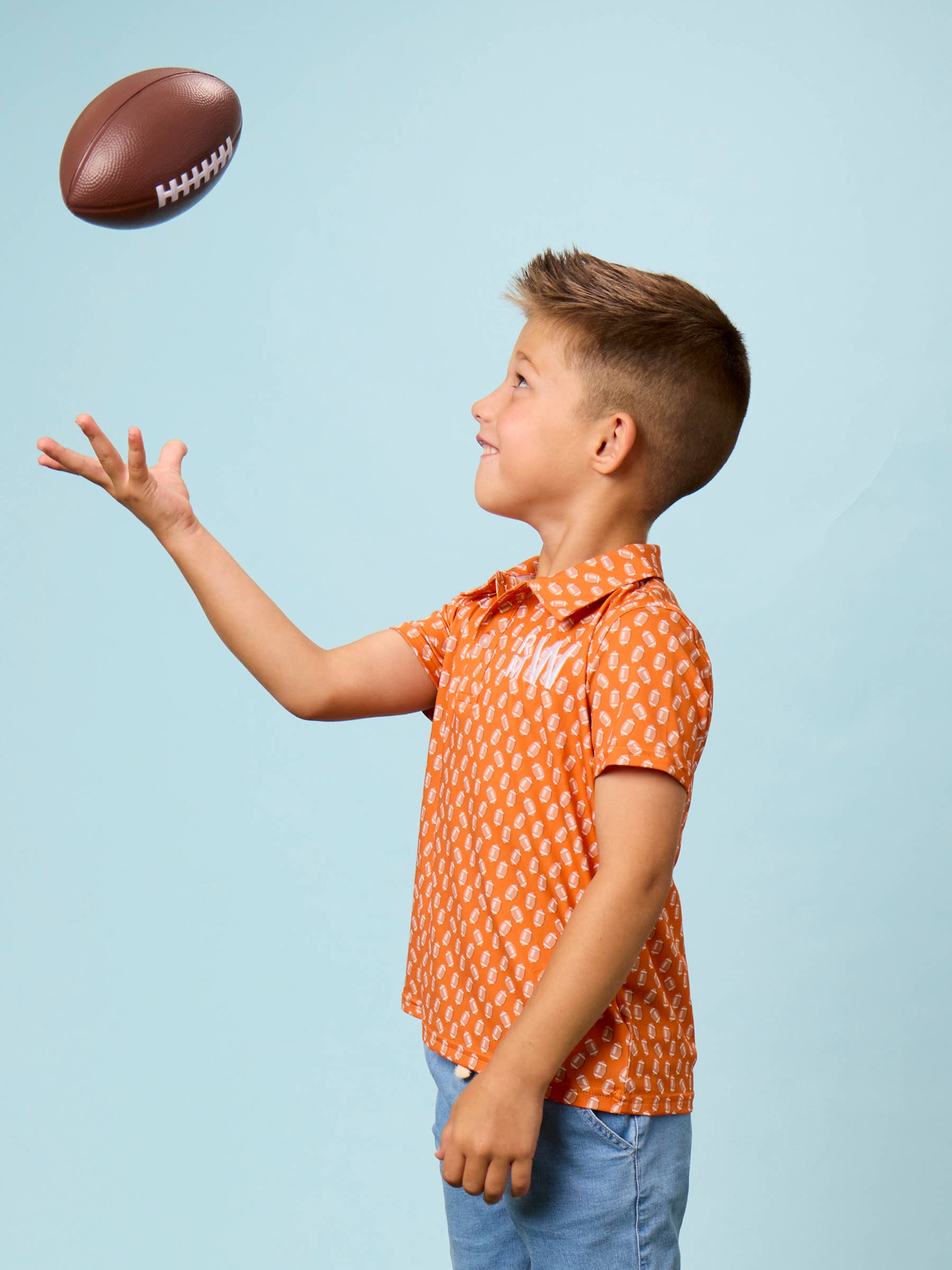 Boys Varsity Orange Football Frenzy Knit Short Sleeve Performance Polo